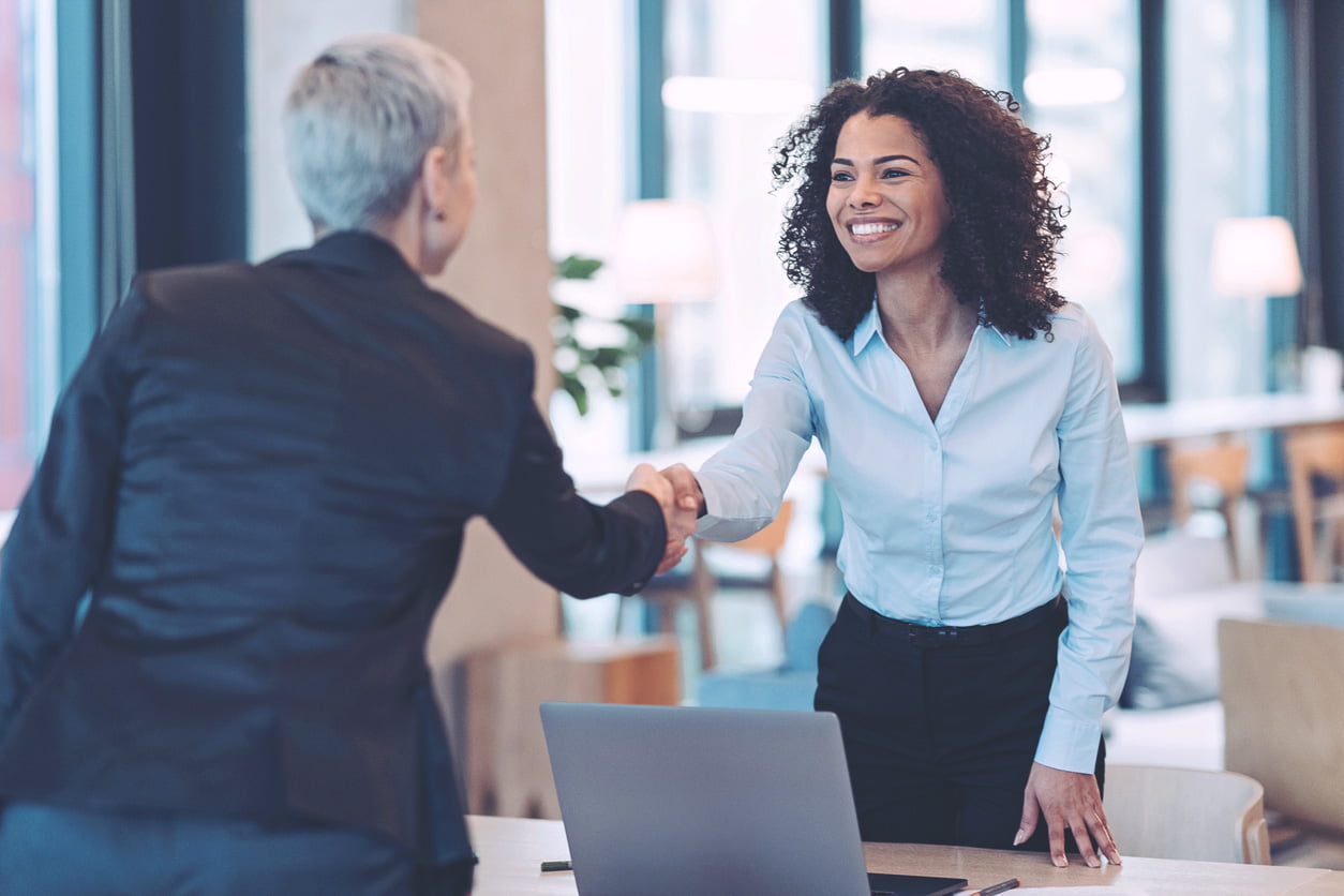 Businesswomen shaking hands in the office